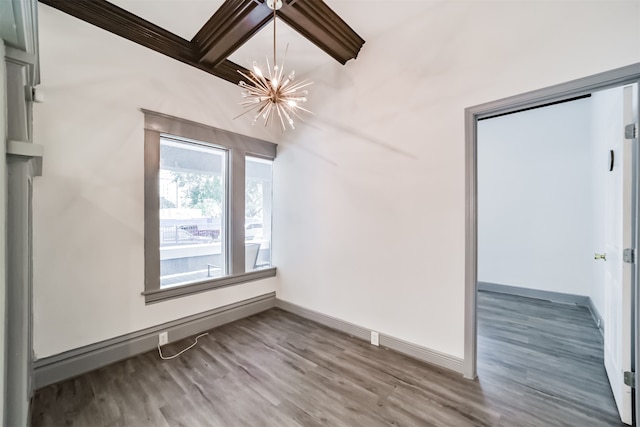 spare room with hardwood / wood-style flooring, an inviting chandelier, and beam ceiling