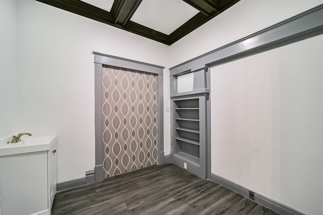 spare room featuring coffered ceiling, dark hardwood / wood-style flooring, and beamed ceiling