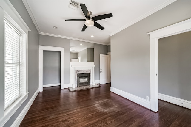 unfurnished living room with ceiling fan, dark hardwood / wood-style flooring, crown molding, and a premium fireplace