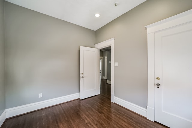 unfurnished bedroom featuring dark wood-type flooring