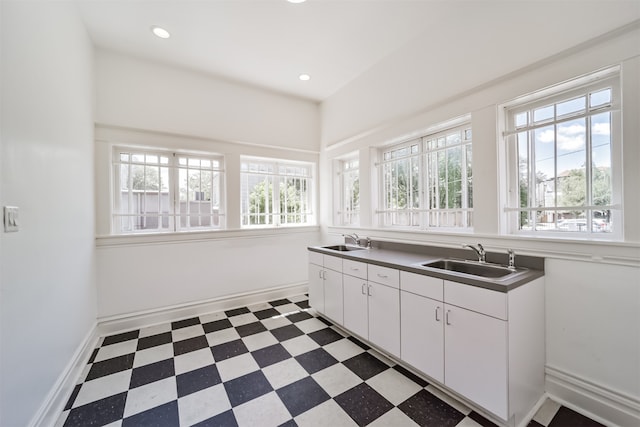 kitchen with sink, white cabinetry, and a healthy amount of sunlight