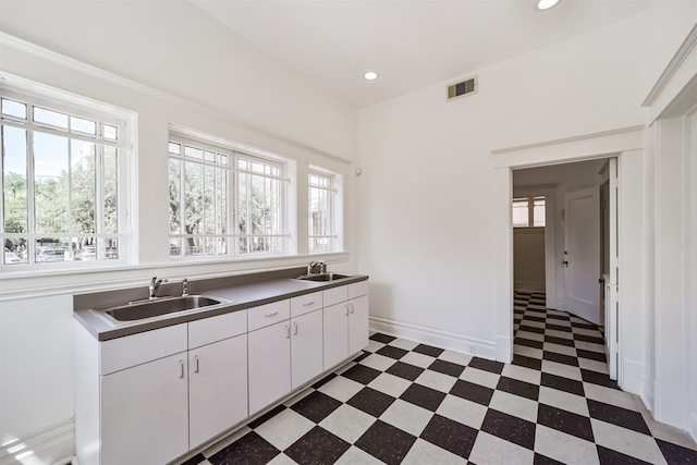 kitchen featuring sink and white cabinets