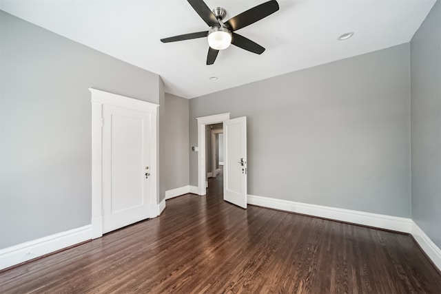 unfurnished bedroom featuring ceiling fan and dark hardwood / wood-style flooring