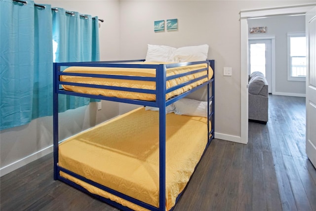 bedroom with dark hardwood / wood-style flooring