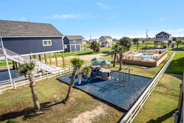 exterior space with a playground and a lawn