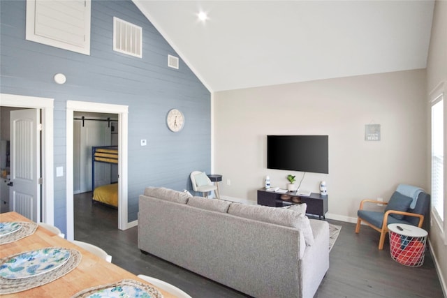 living room featuring wooden walls, high vaulted ceiling, and dark hardwood / wood-style floors