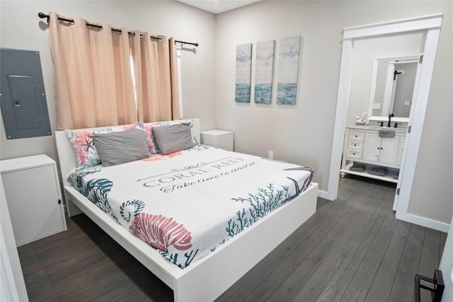 bedroom featuring dark wood-type flooring, ensuite bath, electric panel, and sink