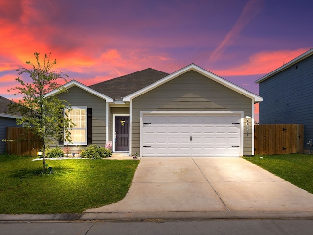 single story home featuring a lawn and a garage