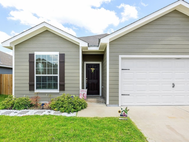 ranch-style home featuring a front lawn and a garage