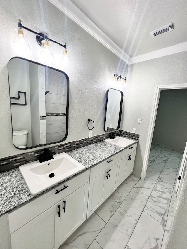 bathroom featuring crown molding, a textured ceiling, toilet, double vanity, and tile patterned flooring