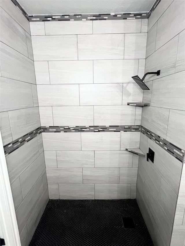 bathroom with tiled shower