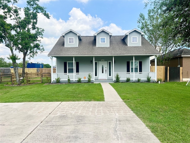 cape cod home with covered porch and a front lawn