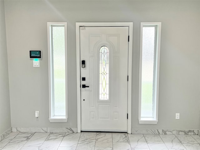 tiled foyer entrance featuring a healthy amount of sunlight