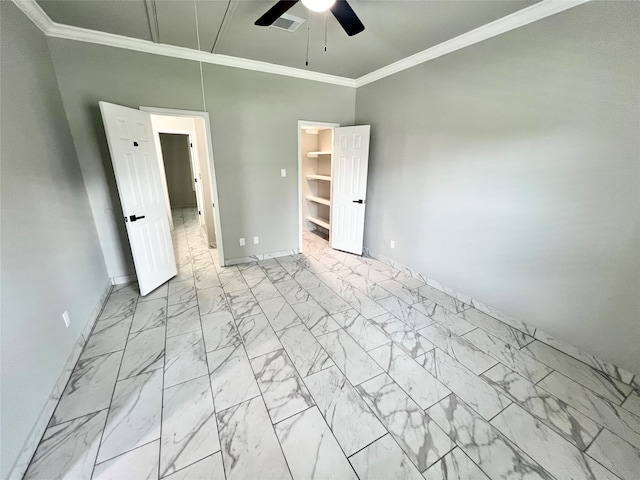 unfurnished bedroom featuring ceiling fan, crown molding, a spacious closet, light tile patterned floors, and a closet