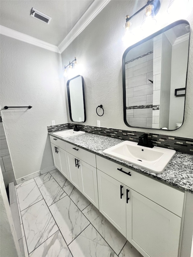 bathroom with double vanity, ornamental molding, tasteful backsplash, and tile patterned flooring