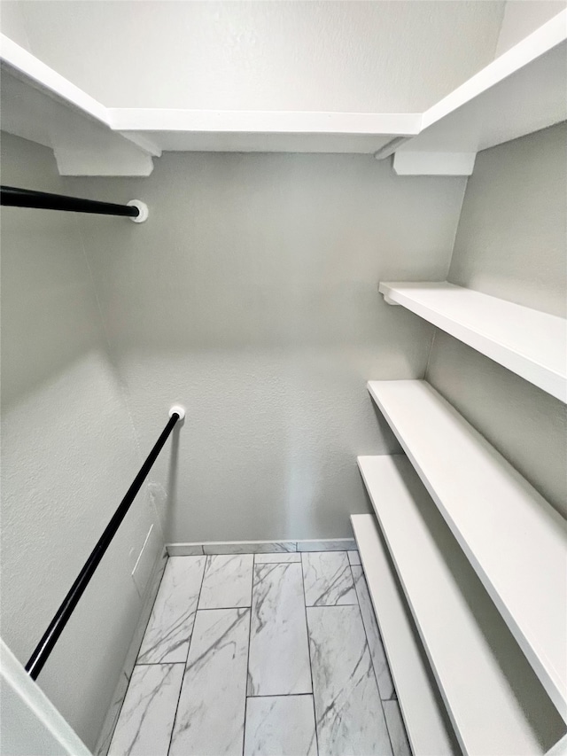 walk in closet featuring light tile patterned flooring