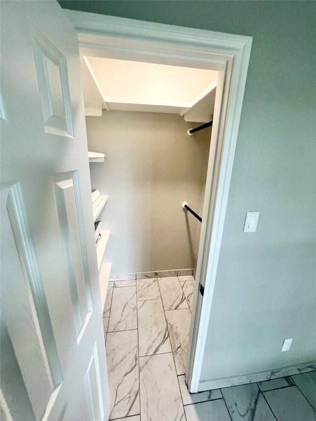 spacious closet featuring light tile patterned floors