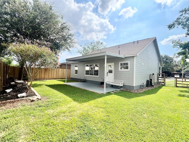 rear view of house with a patio area and a lawn