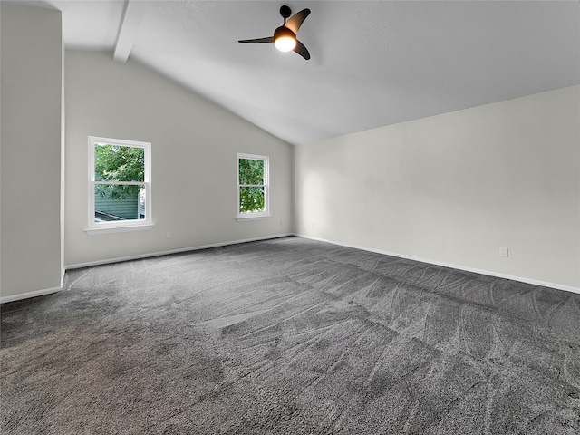 carpeted spare room featuring vaulted ceiling with beams, ceiling fan, and a healthy amount of sunlight