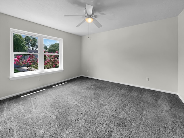 spare room with ceiling fan and carpet