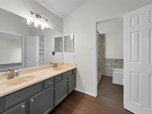 bathroom with separate shower and tub, vanity, and wood-type flooring