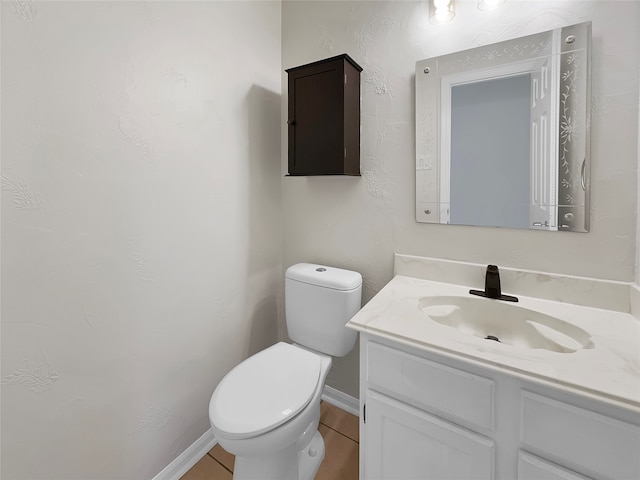 bathroom with tile patterned floors, vanity, and toilet