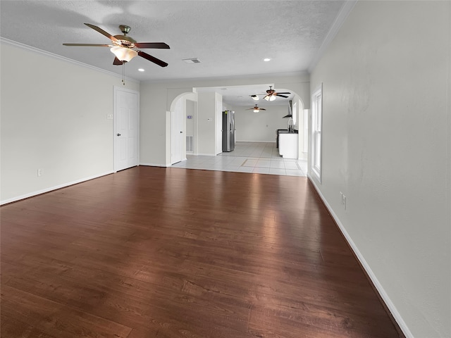 unfurnished living room featuring ceiling fan, a textured ceiling, and light hardwood / wood-style floors