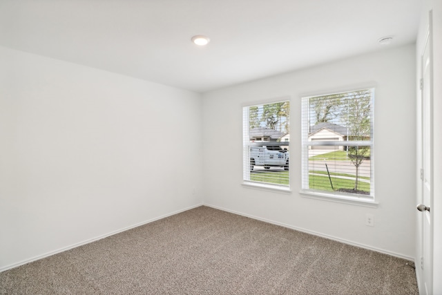 unfurnished room featuring carpet