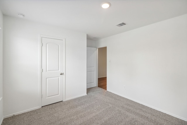 unfurnished bedroom featuring carpet and a closet