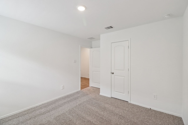 unfurnished bedroom featuring light colored carpet