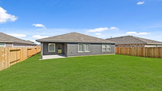 back of house featuring a patio area and a yard