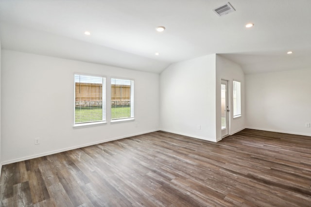 unfurnished room featuring dark hardwood / wood-style floors and vaulted ceiling