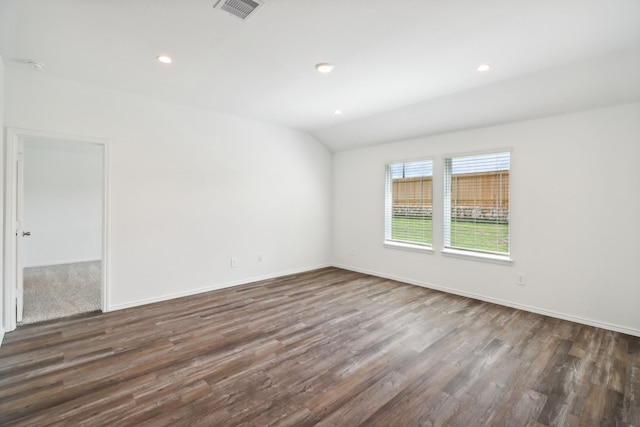 empty room with lofted ceiling and dark wood-type flooring