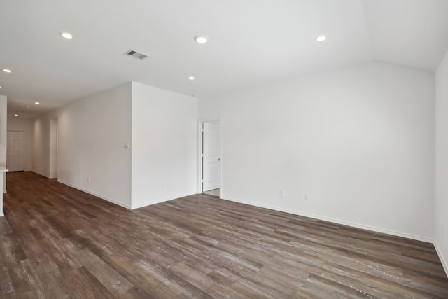 unfurnished room featuring dark hardwood / wood-style floors and vaulted ceiling