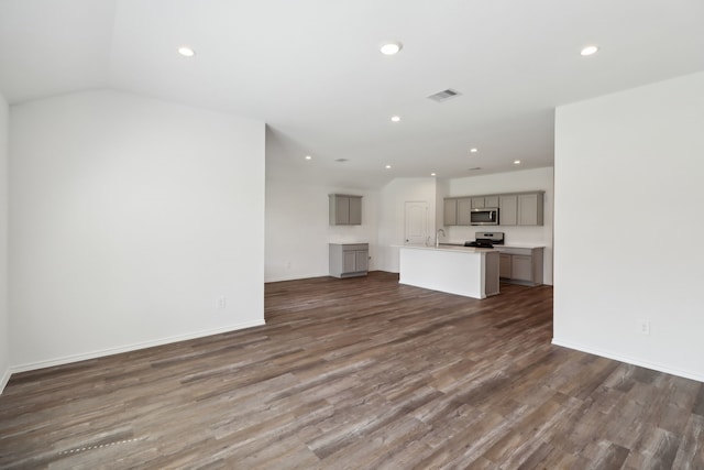 unfurnished living room featuring sink and dark wood-type flooring