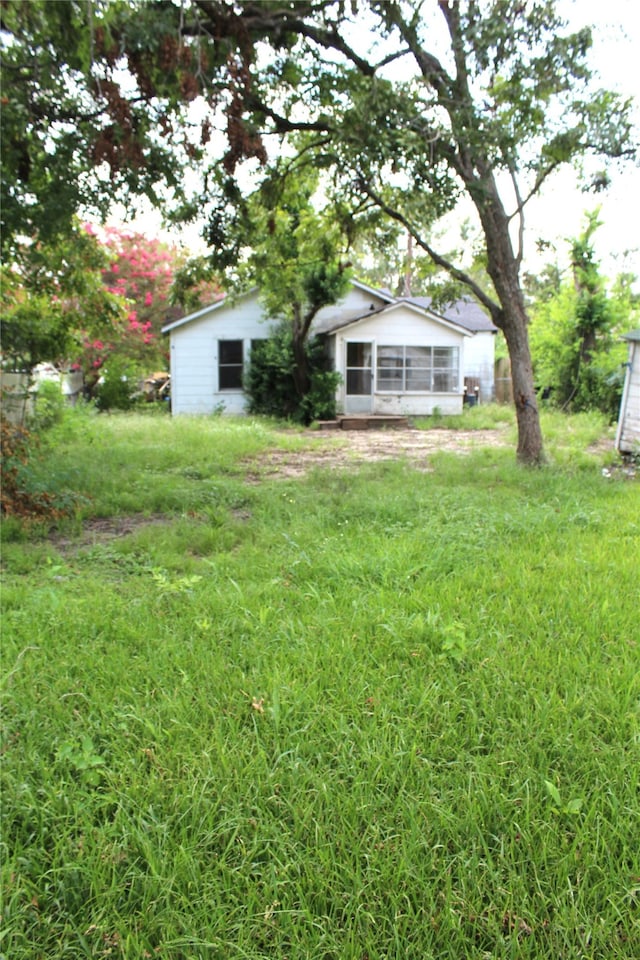 view of yard featuring a sunroom