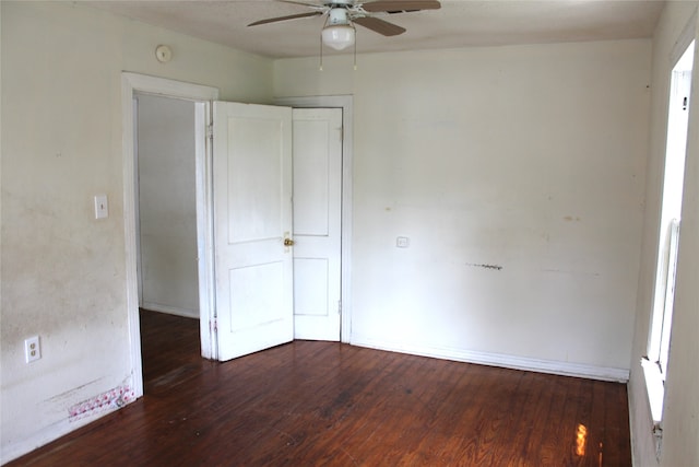 unfurnished bedroom with dark hardwood / wood-style floors and ceiling fan