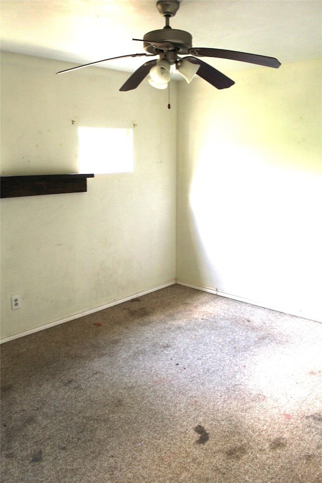 unfurnished room with ceiling fan and carpet floors