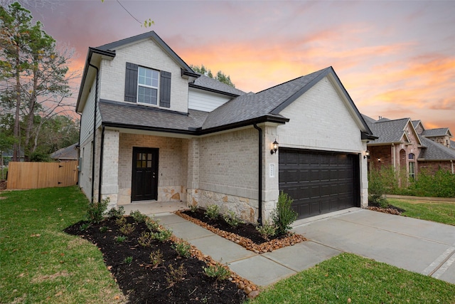 view of front of home with a lawn and a garage