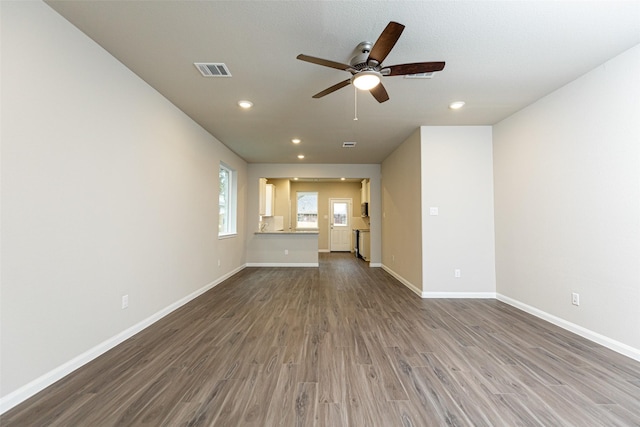 unfurnished living room with hardwood / wood-style floors and ceiling fan