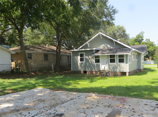 back of property with a patio area and a yard