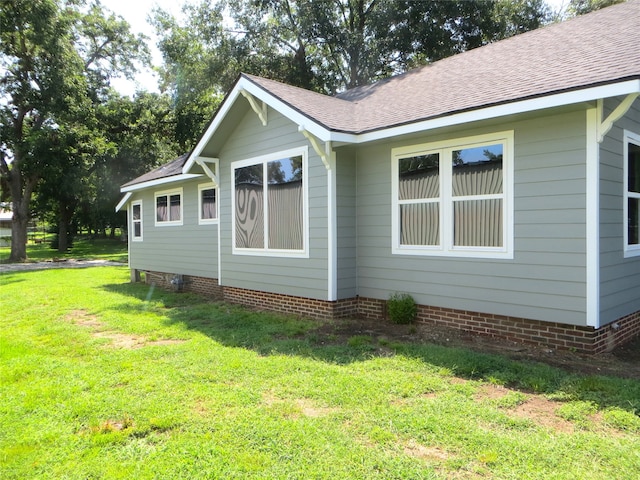 view of side of property with a yard