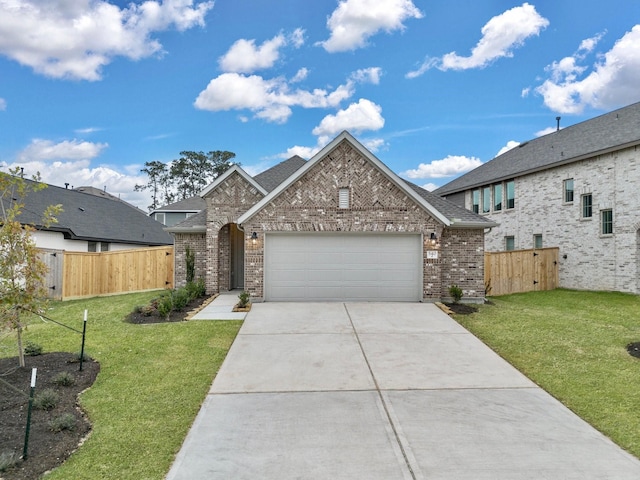 view of front of property featuring a front lawn and a garage