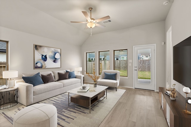 living room featuring vaulted ceiling, ceiling fan, and light hardwood / wood-style floors