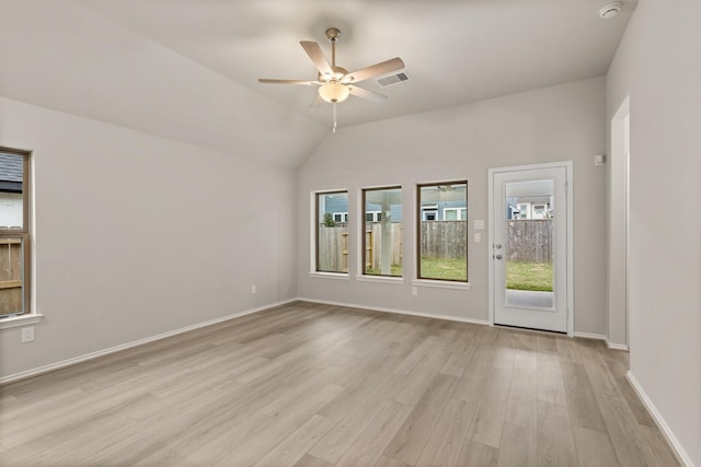 empty room with lofted ceiling, ceiling fan, and light hardwood / wood-style flooring