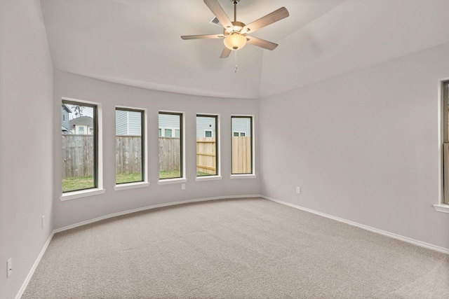 carpeted spare room featuring high vaulted ceiling and ceiling fan