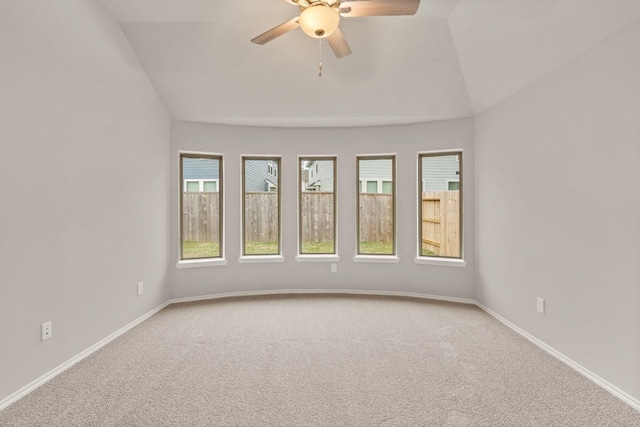 carpeted empty room featuring lofted ceiling and ceiling fan