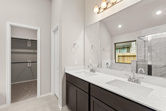 bathroom featuring tile patterned flooring, walk in shower, and vanity