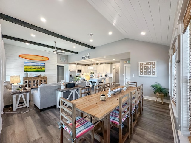 dining space featuring ceiling fan, lofted ceiling with beams, and dark hardwood / wood-style flooring