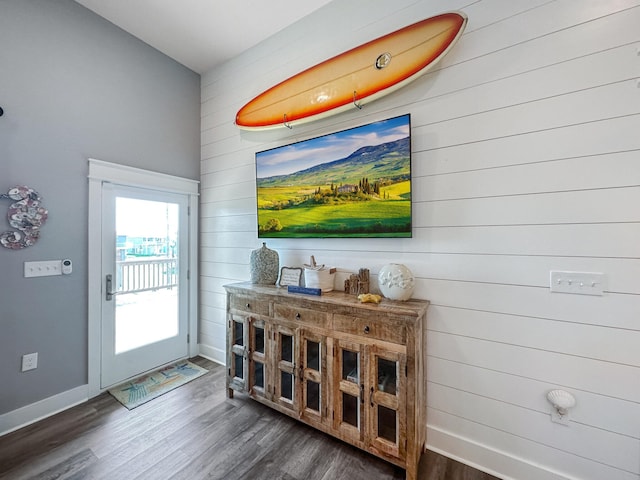 interior space with baseboards and dark wood-style flooring